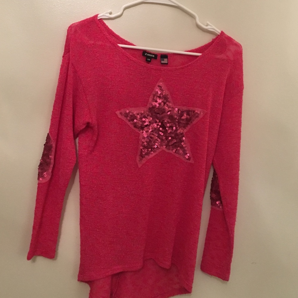 pink shirt with pink sparkly star on front.