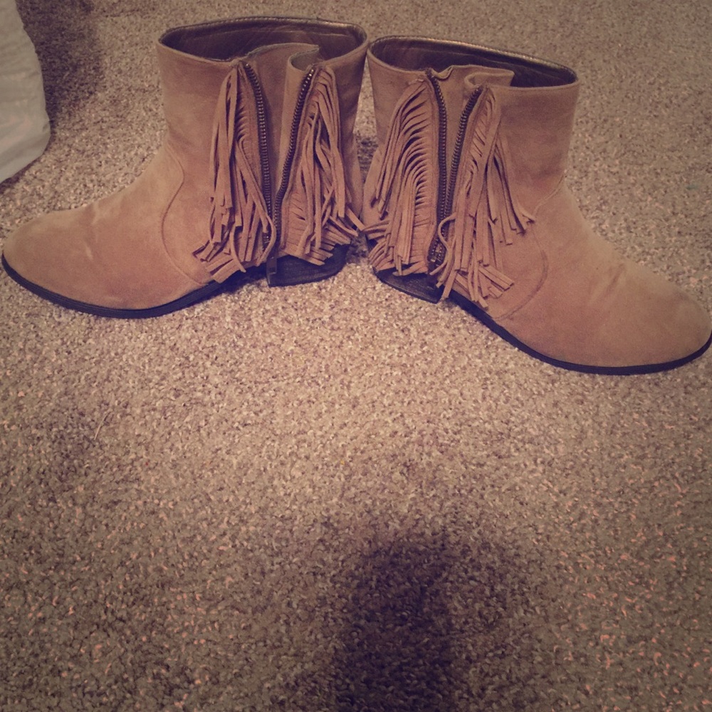 Brown fringe boots slightly above the ankle