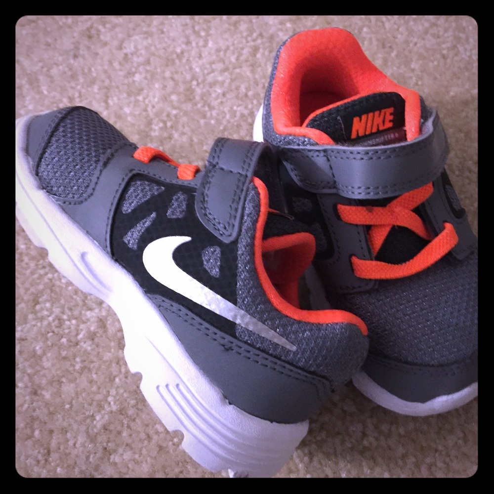Kid's neon orange and gray Nikes