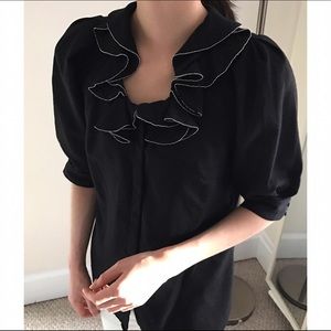 Jill Stuart ruffle neck line wool blouse in black.