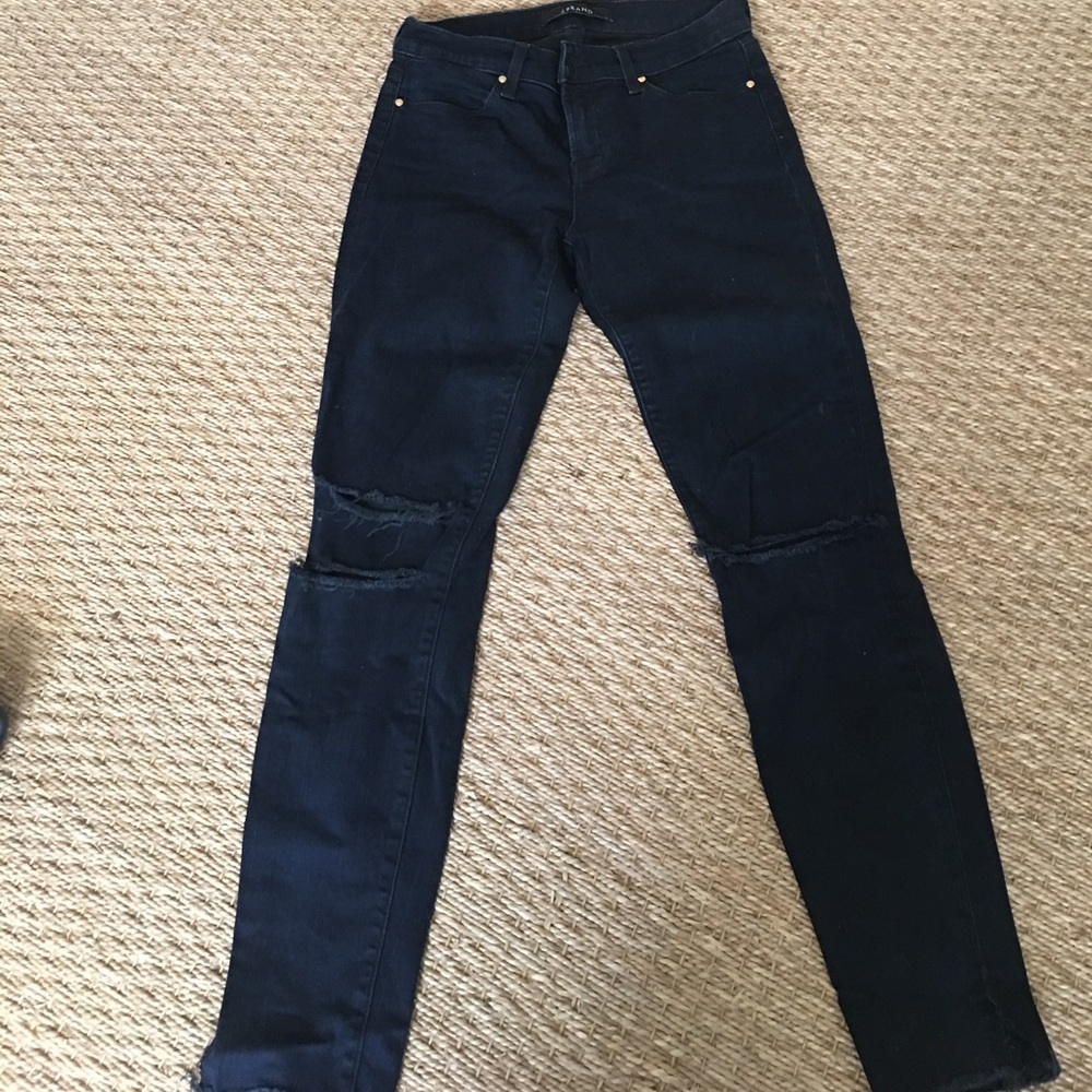 JBrand dark ink stretch skinny jeans with holes.