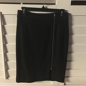 Black skirt with gold zipper.