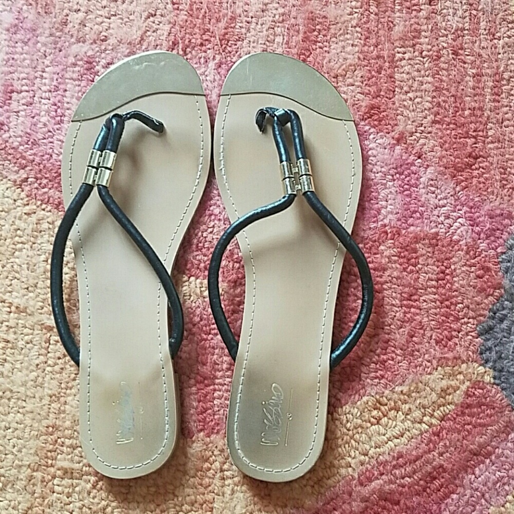 Black sandals with gold metal tips