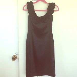 Black satin dress with rosette neckline.