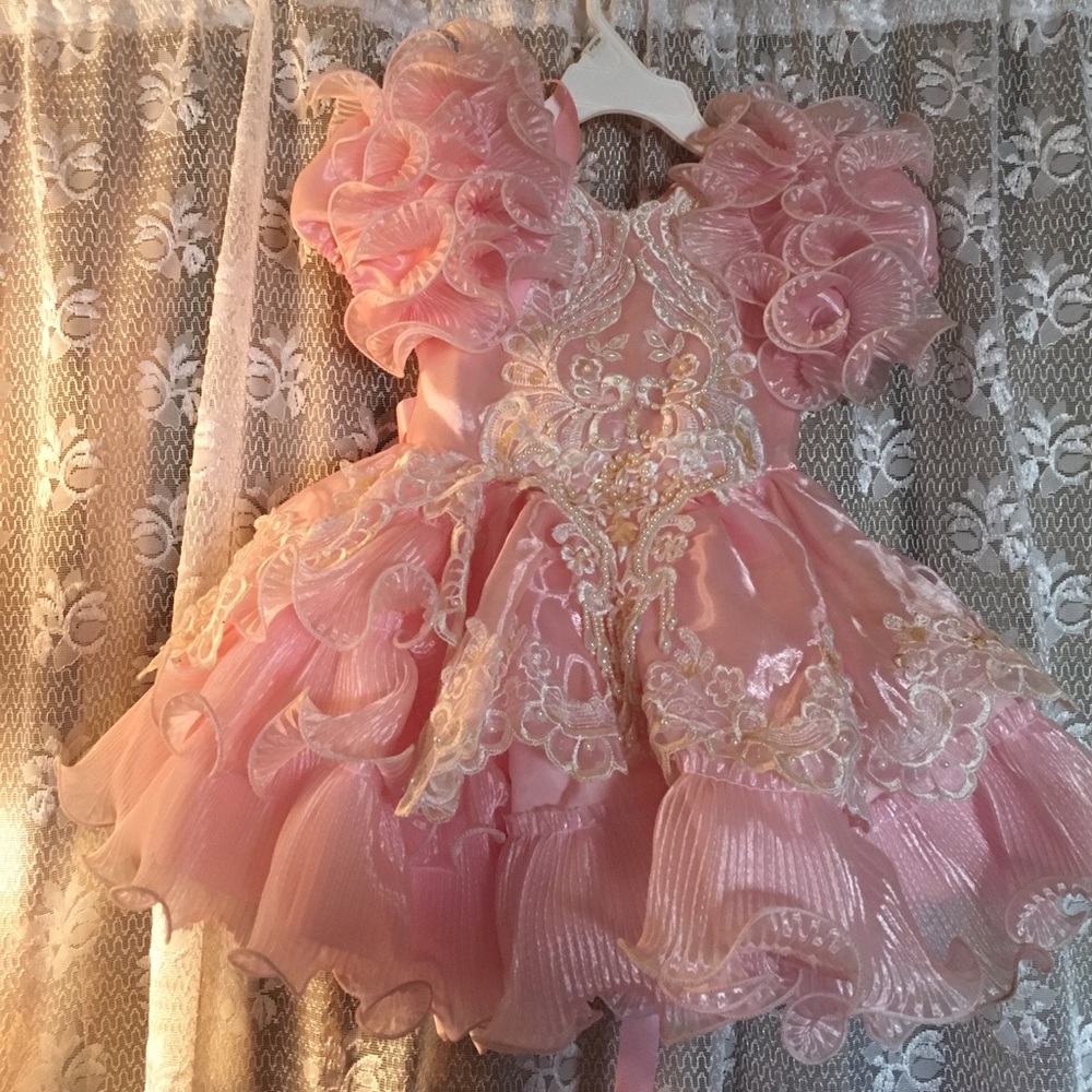 Selling a light pink baby girl pageant dress.