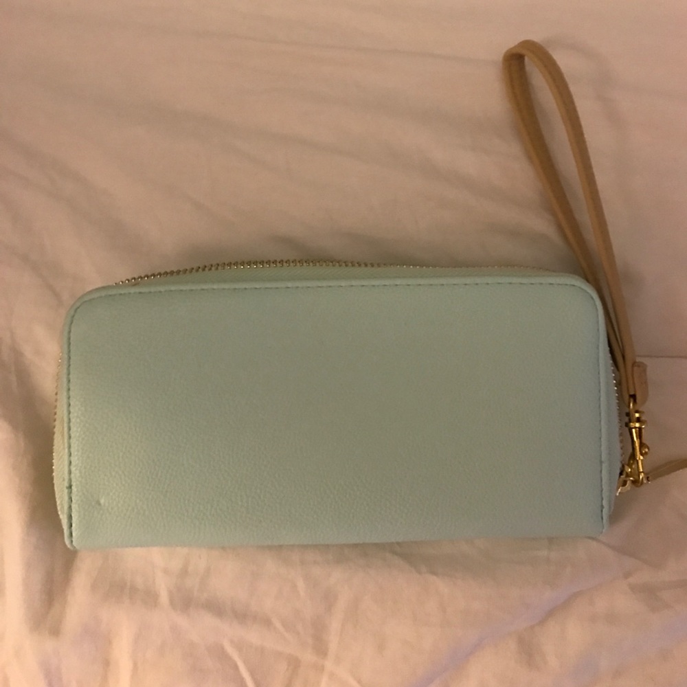 Light mint wristlet with gold accents.