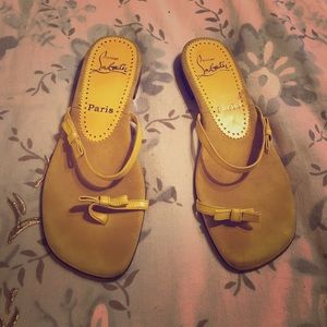 Yellow Christian Louboutin flip flops