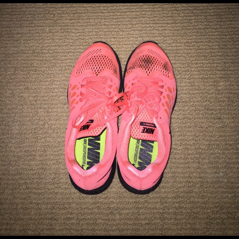 Salmon colored Nike running shoes