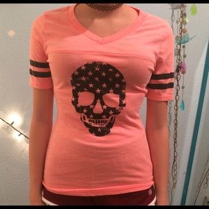 A Pink Tee Shirt With A Skull On It