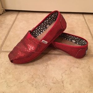 TOMS red sparkle shoes.