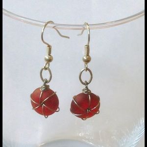 Handmade earrings with wire wrapped red  beads.