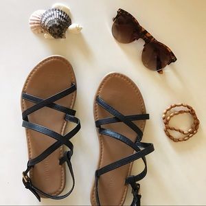black faux leather cross sandals