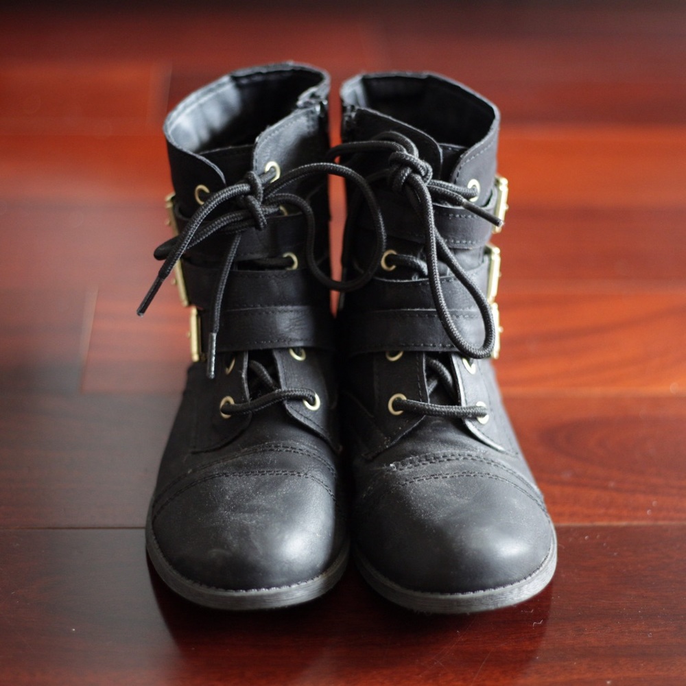 Black moto ankle boots with gold buckles