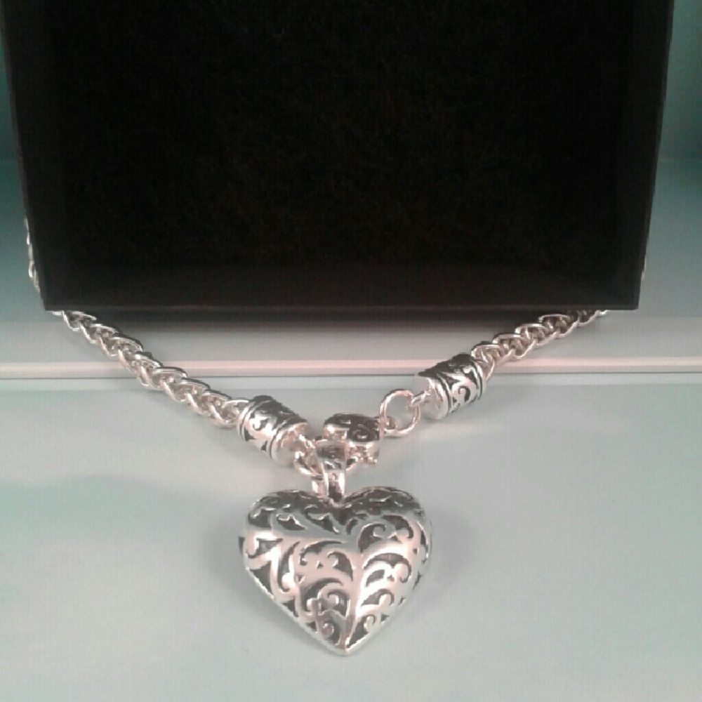 Silver heart enameled detail latches in front
