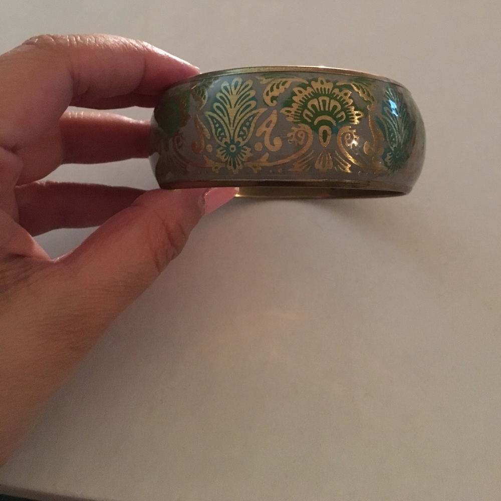 Golden cuff with green and grey artwork
