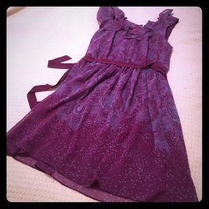 Sleeveless purple dress with an underlay.