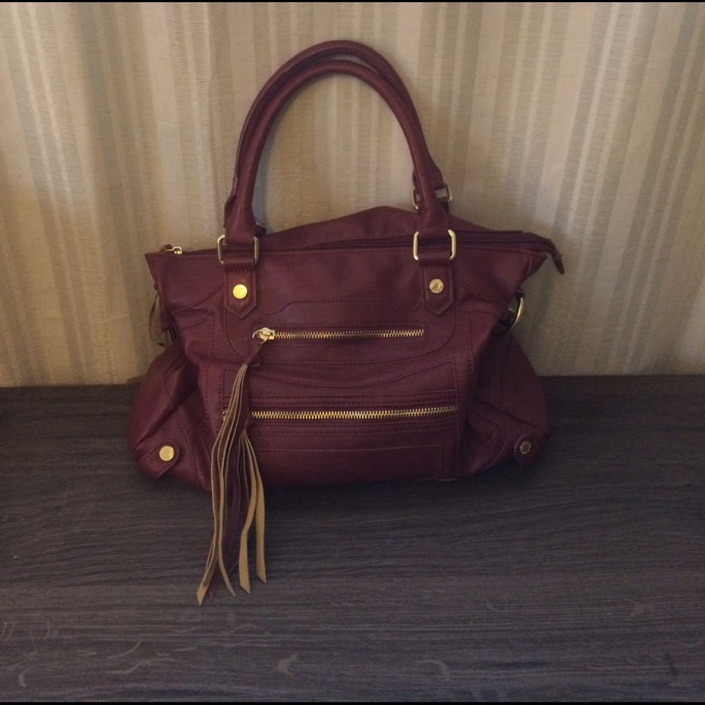 Steve Madden maroon bag with shoulder strap.