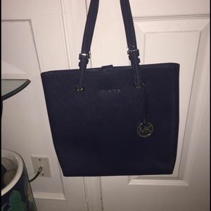 Navy blue Michael Kors handbag.