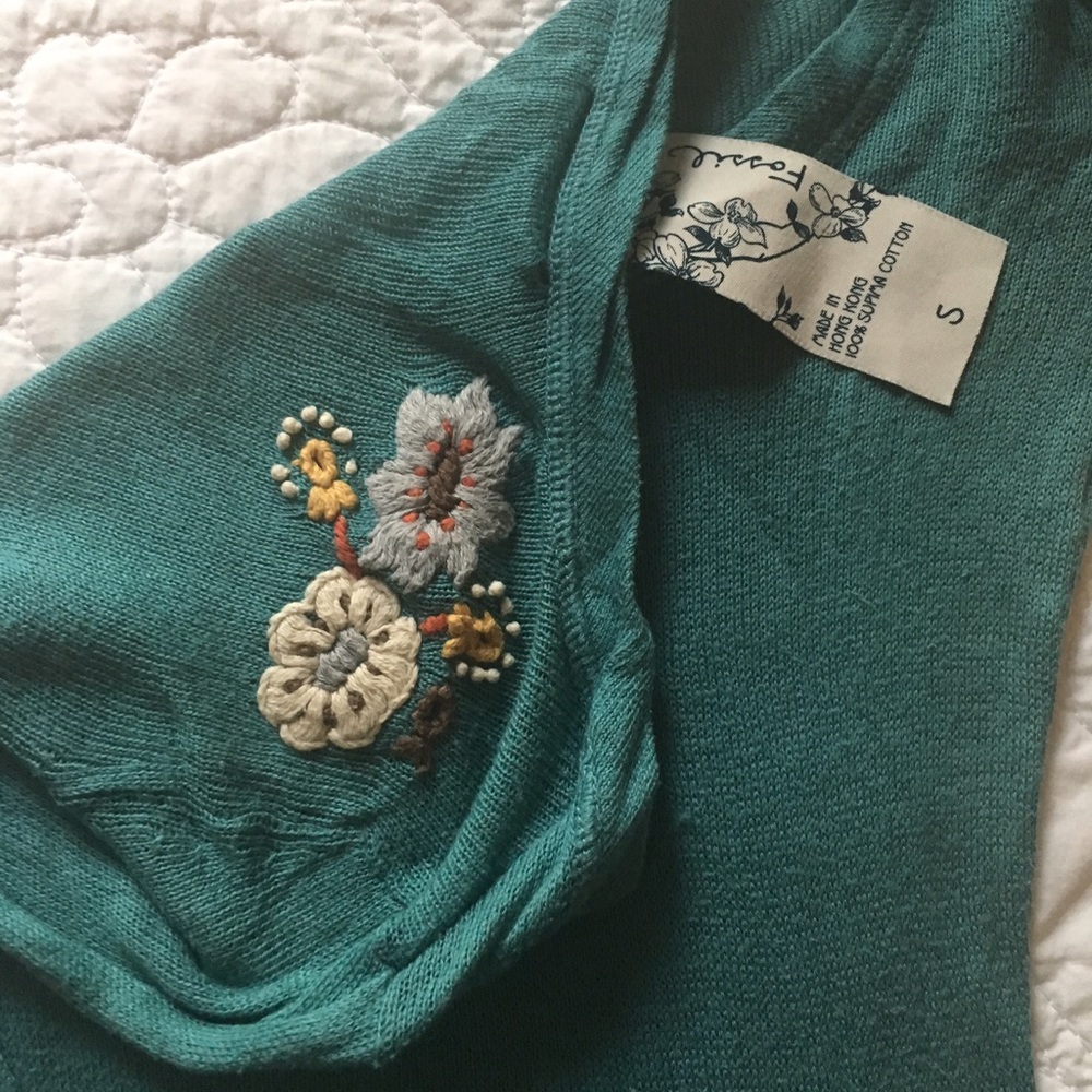 Fossil blue sweater with embroidered detail.