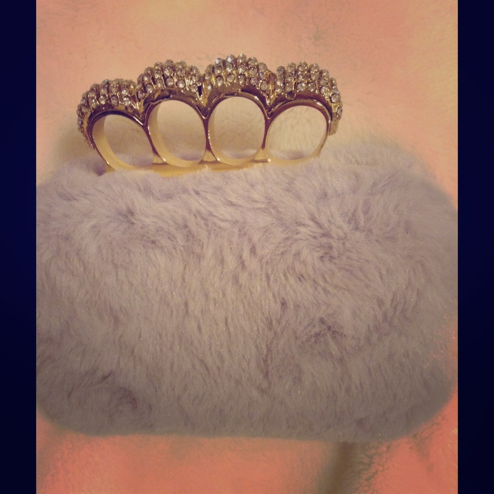 Brass knuckle clutch bag
