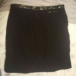 Black skirt with pockets, zipper, and buttons