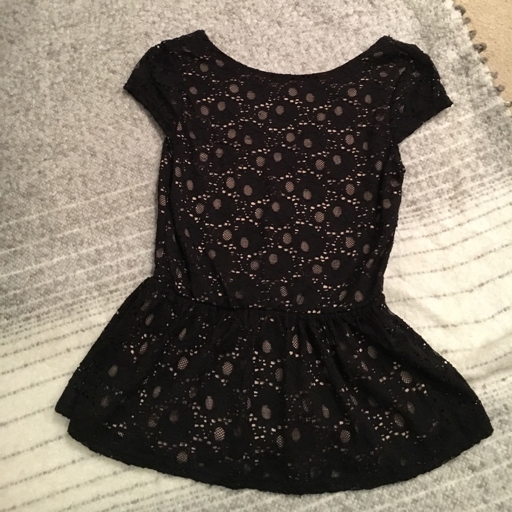 Black and nude peplum top