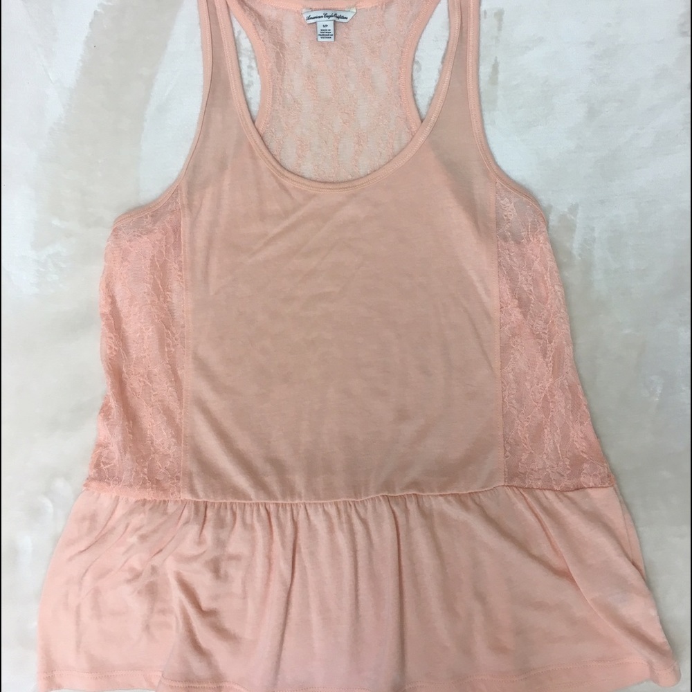 Small top, pink peach color. Loose fitting