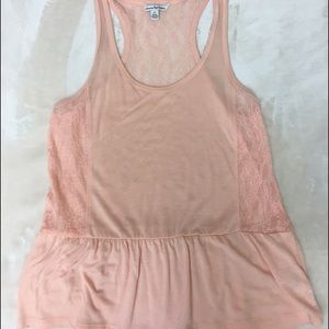 Small top, pink peach color. Loose fitting