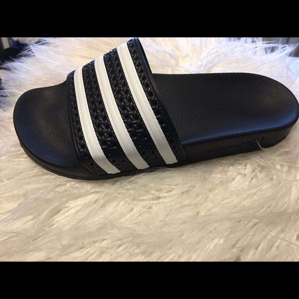 Black & white striped Adidas slides