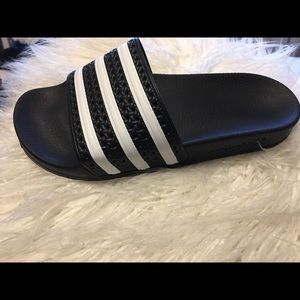 Black & white striped Adidas slides