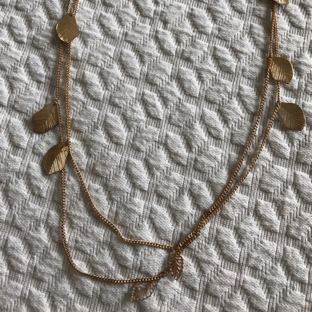 Long gold tone necklace with leaves