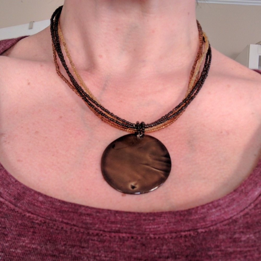 Amber colored pendent and beaded necklace
