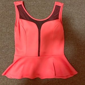 Peplum tank top with tasteful mesh lining.
