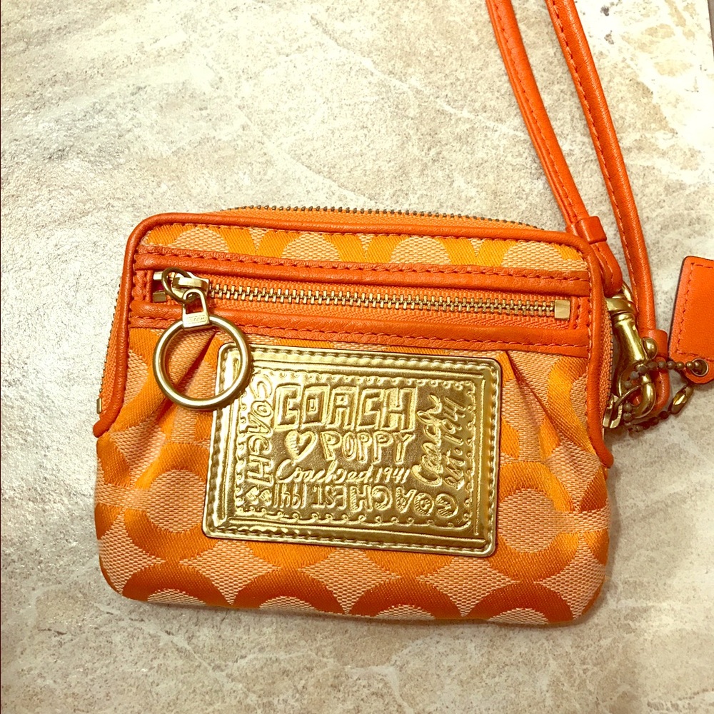 Orange and gold coach wristlet wallet. 4"x5".