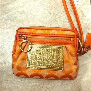 Orange and gold coach wristlet wallet. 4"x5".