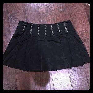 Black satin pleated mini skirt. BEBE NWT