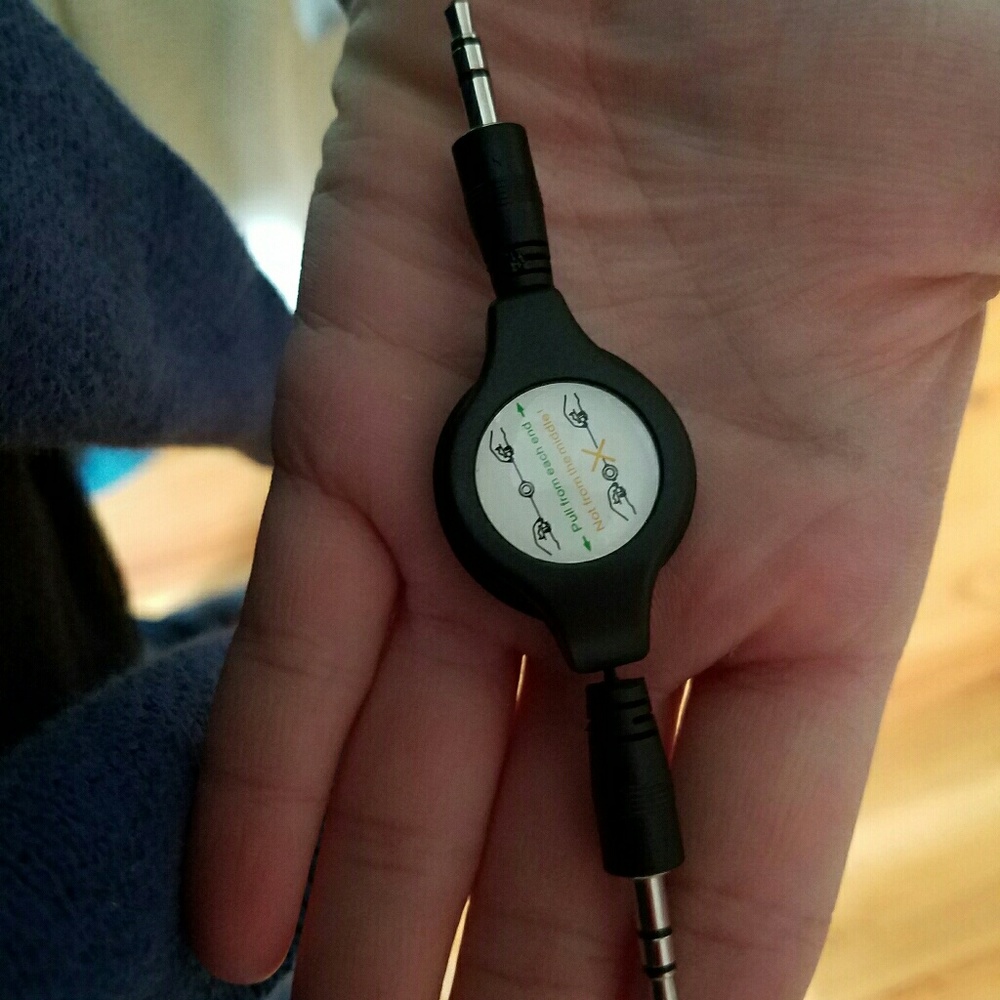 Retractable aux auxiliary cord