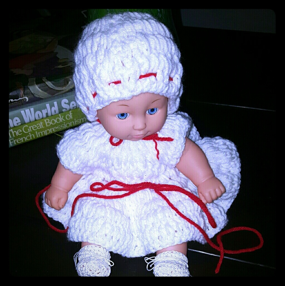 Doll with hand knit dress, hat and booties