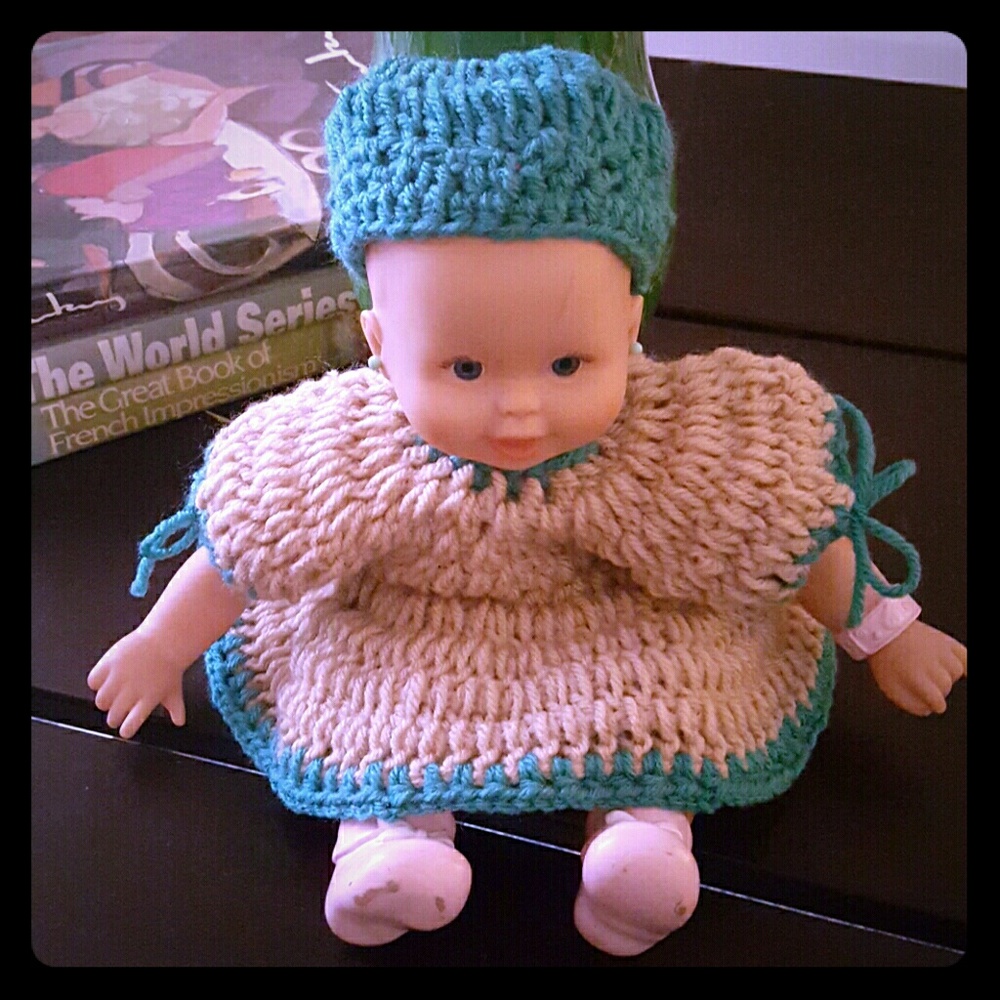 Doll in hand knit dress with matching hat