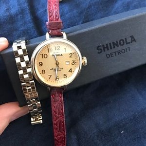 Shinola watch with gold face, red alligator band