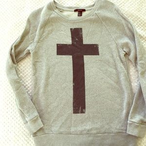 Sweater with Cross graphic.