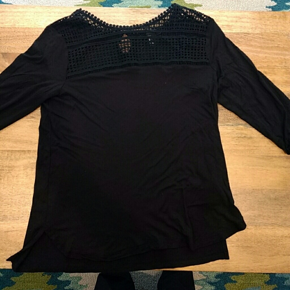 Black shirt with lace detail in the front.