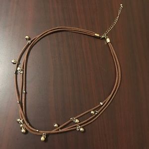 Cord and gold tone necklace