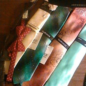 4 brand new ties and 2 brand new bow ties