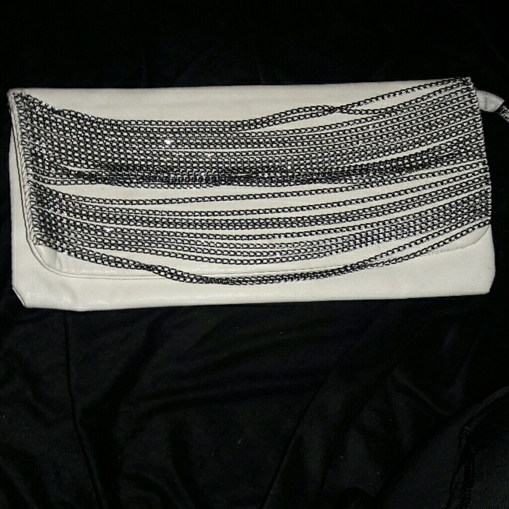 White clutch with edgy chain embellishments
