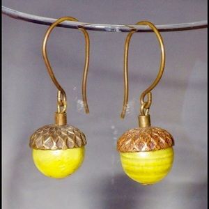 Earrings with metal acorn top over green beads