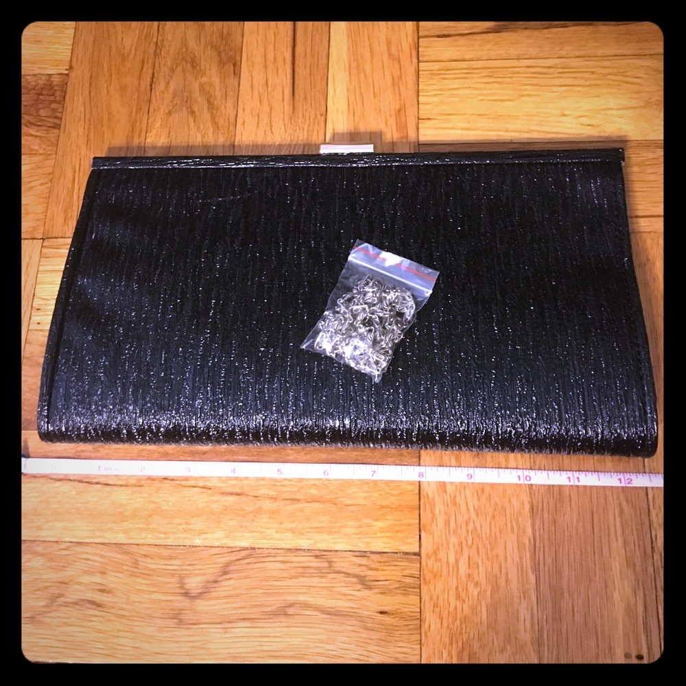 Black coated clutch. Comes with strap