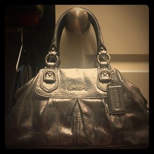 Silver metallic coach purse