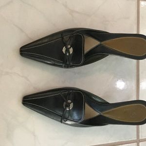 Cole Haan black mules with stitching