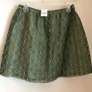 Green circle on short skirt